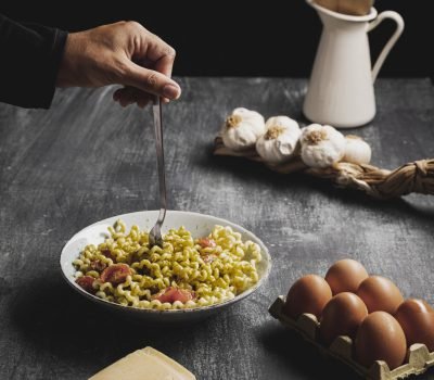 close-up-person-with-curly-pasta-bowl